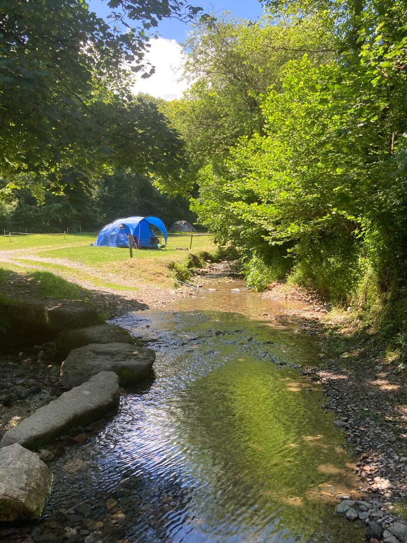 Tent pitch beside a stream