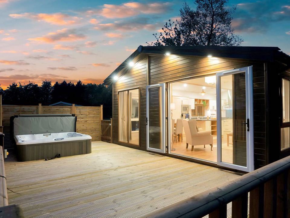 Lodge with hot tub at dusk