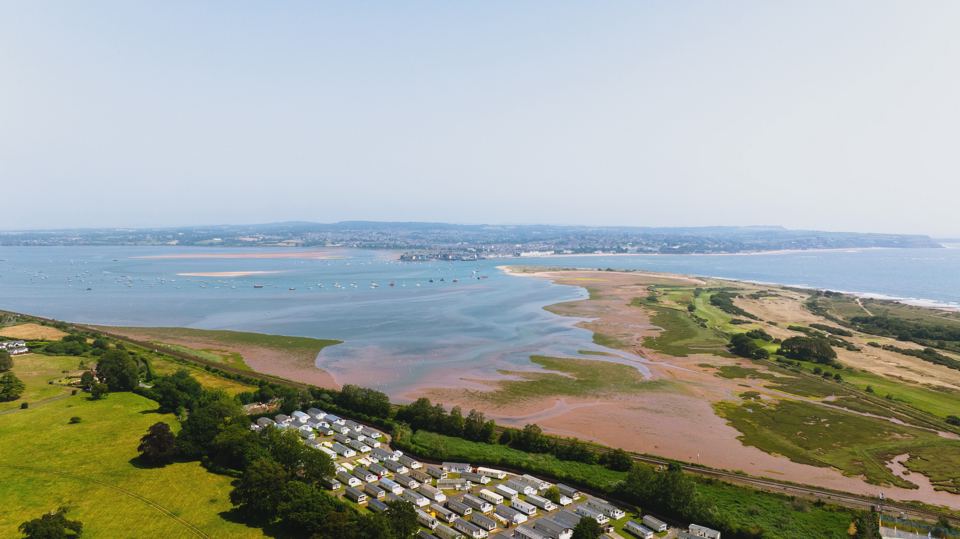 Aerial view over the estuary and caravans