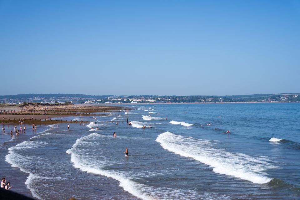 Waves and surfers at the beach