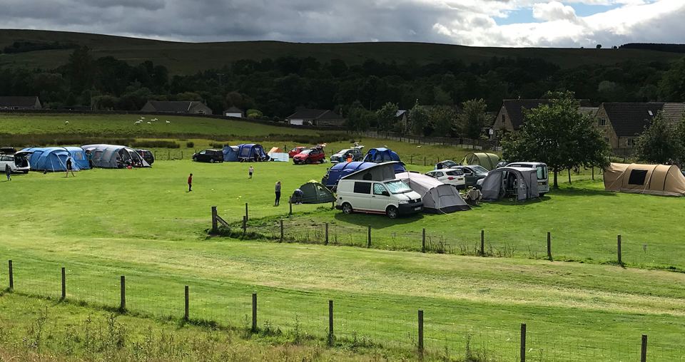 Tents and campervan on the grass