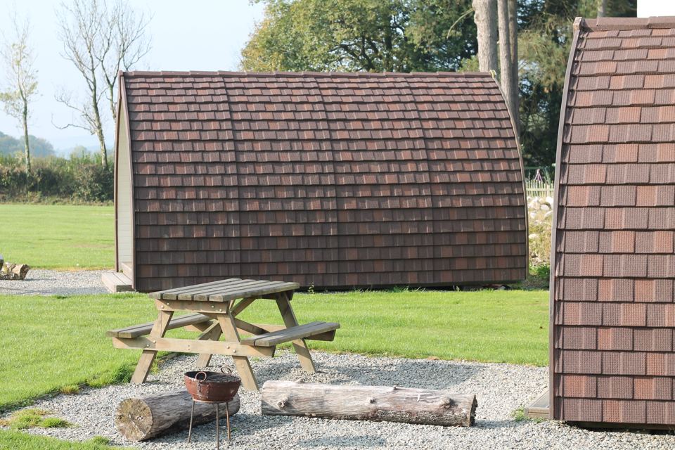 Wooden pods with a fire pit