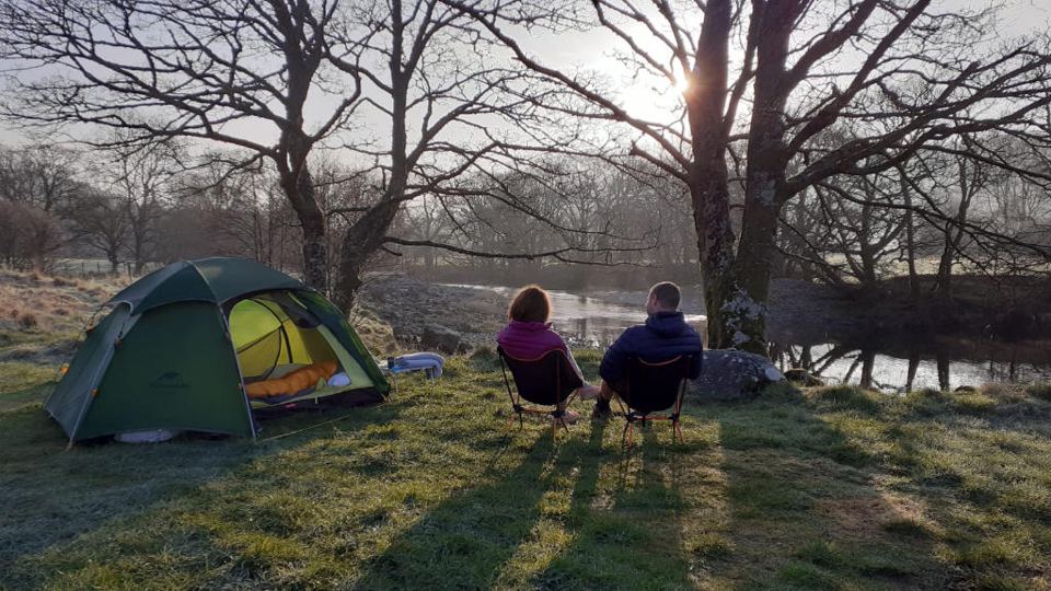 Tent under the trees by the river