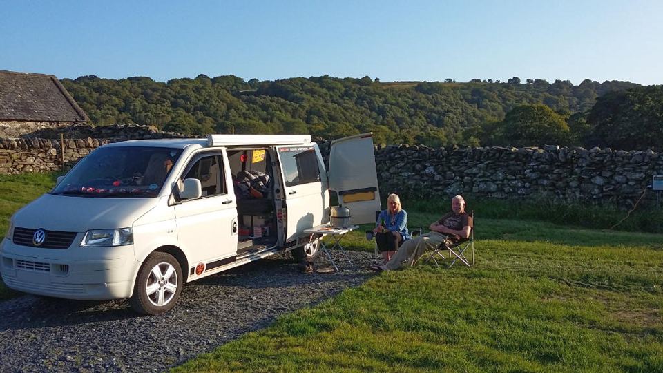 Campervan pitch with stone wall
