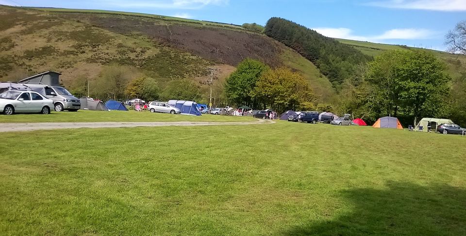 Vans and tents in the valley field