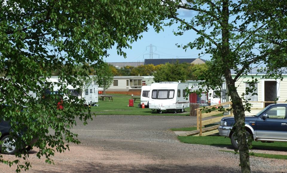Hardstanding tourers beside the lane