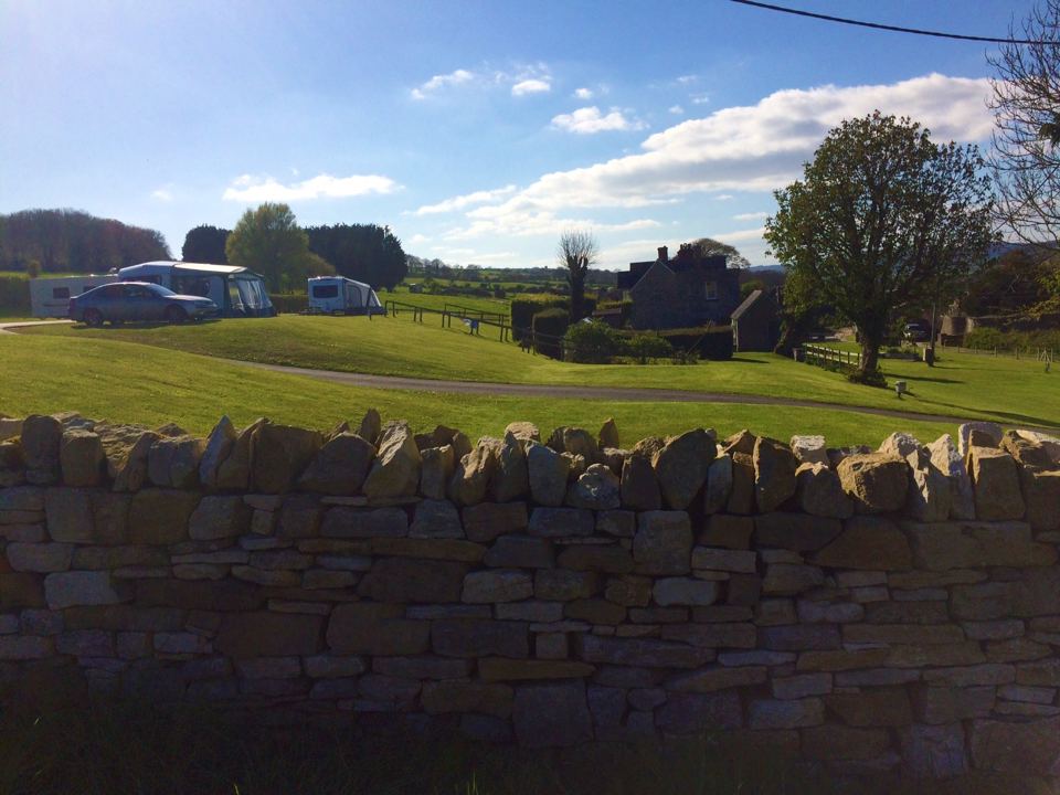 Caravan site behind the stone wall
