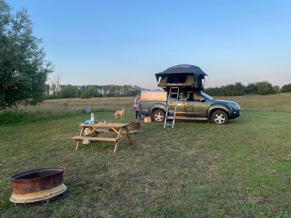 Rooftop tent beside a fire pit