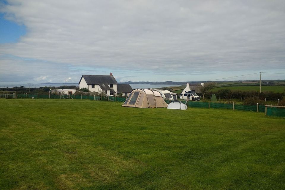 Tents on the grass by the farm