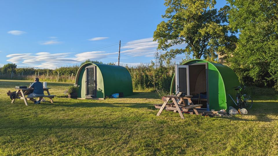 Green pods with picnic benches