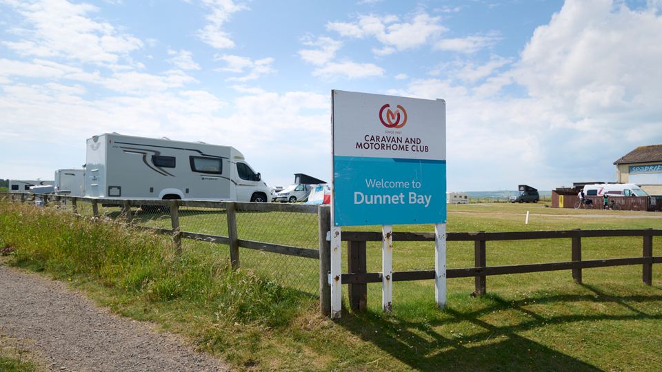 Motorhome by the site sign