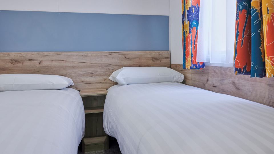 Twin beds in caravan bedroom