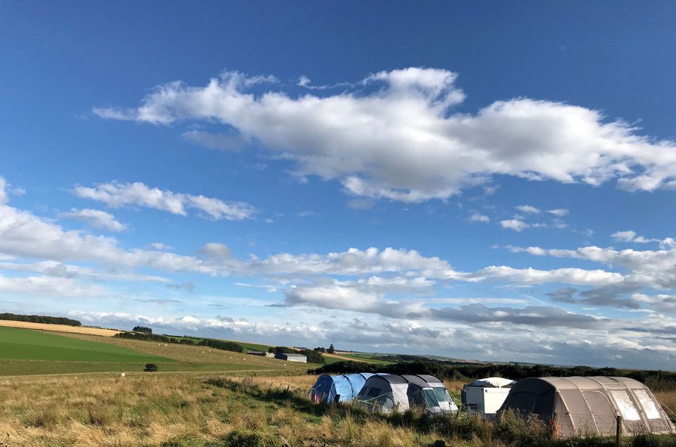 Tents with open farmland views
