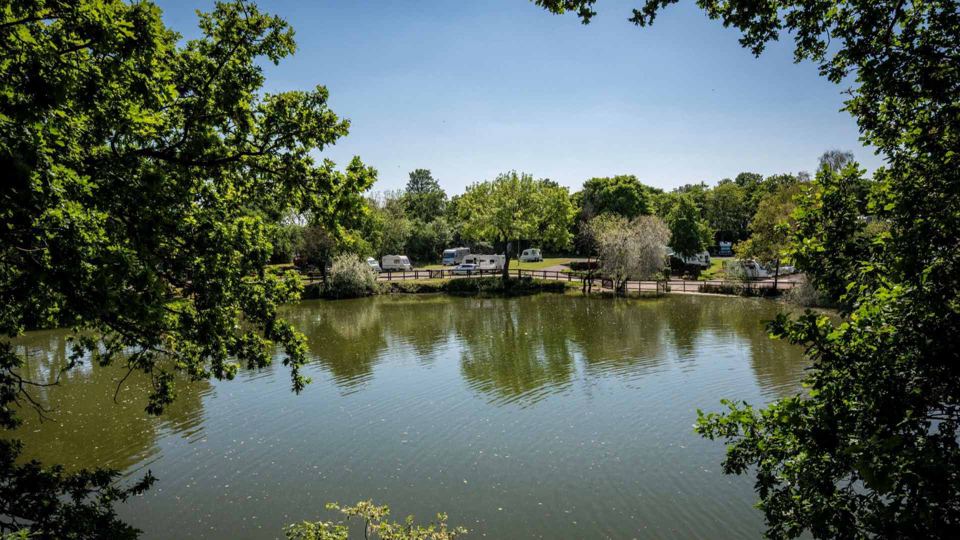 Lake with pitches beyond