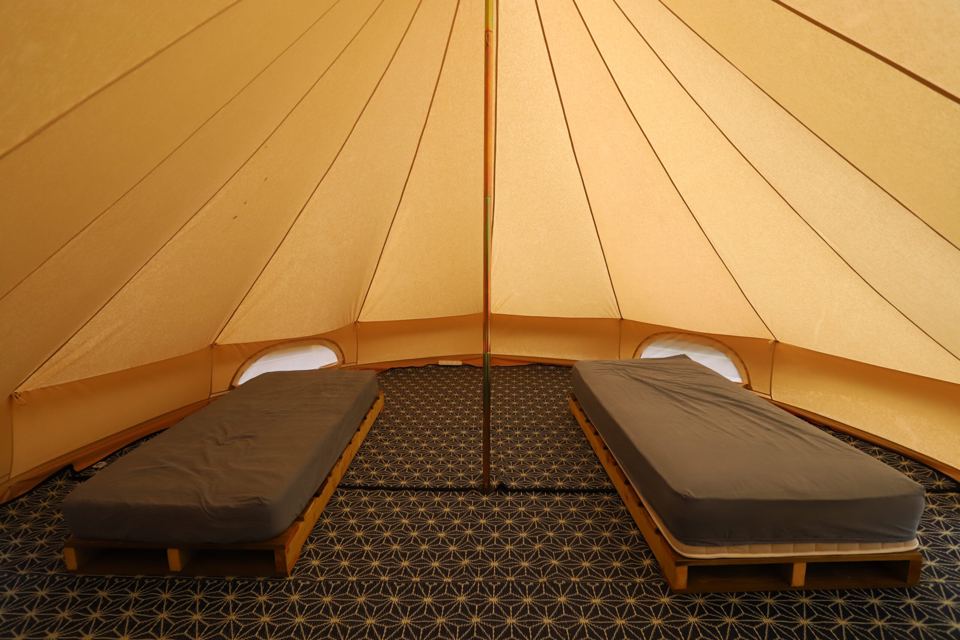 Inside a bell tent with two beds