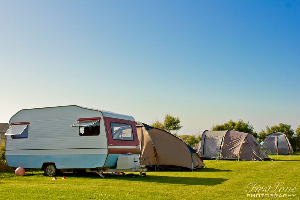 Caravan and tents on the meadow