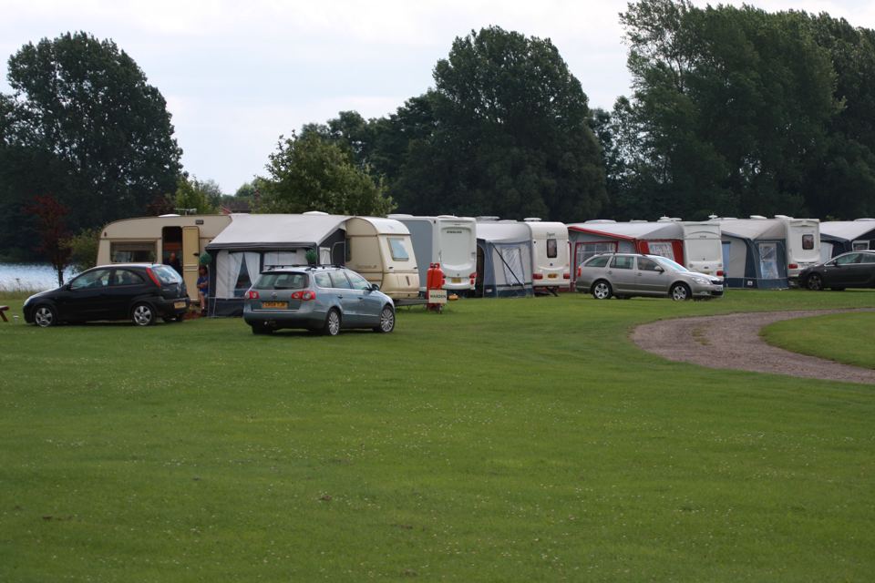 Row of tourers by the lake