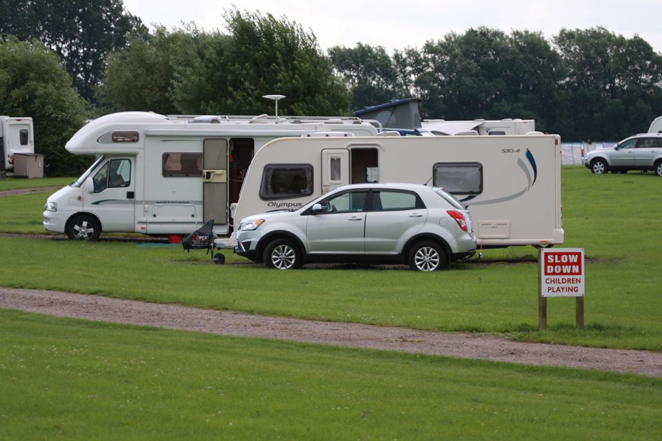 Motorhome and car on grass