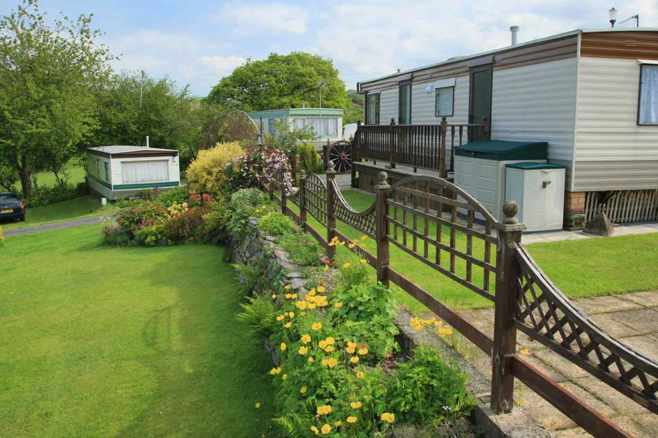 Static caravans among flower beds