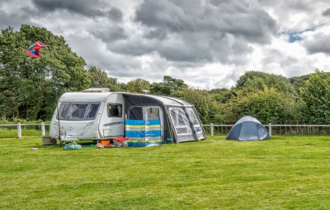 Caravan and tent on grass