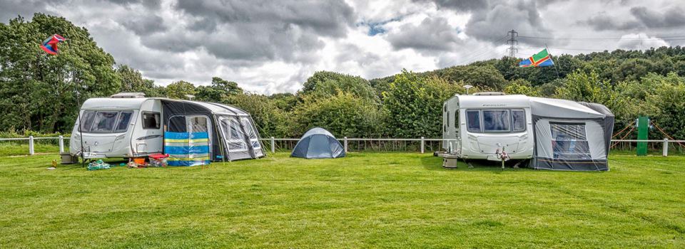 Caravans and a tent on the grass
