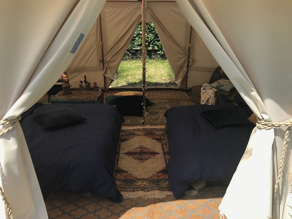 Two beds inside a bell tent