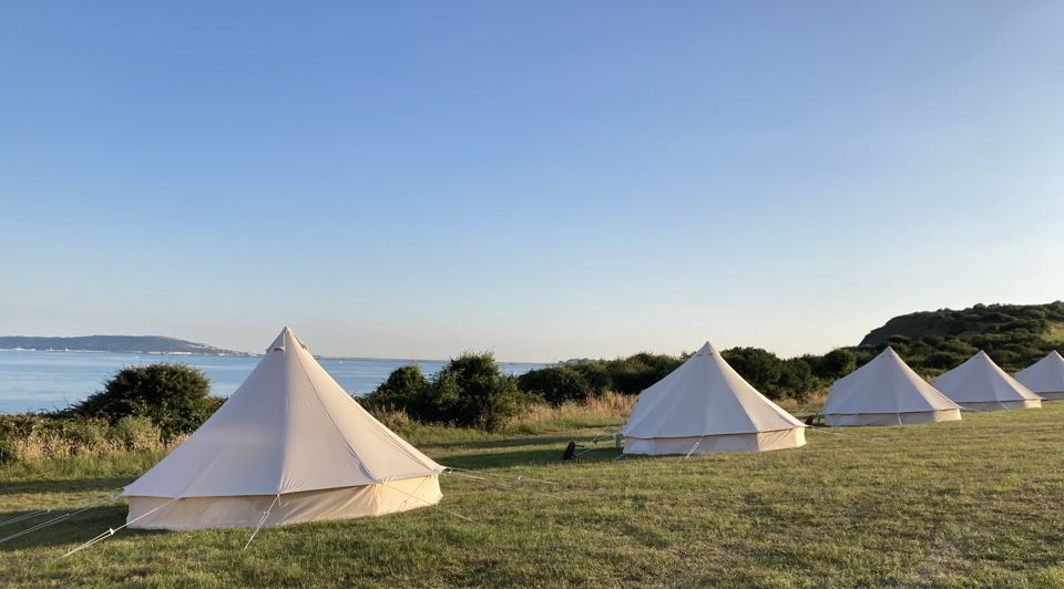 Bell tents above the sea