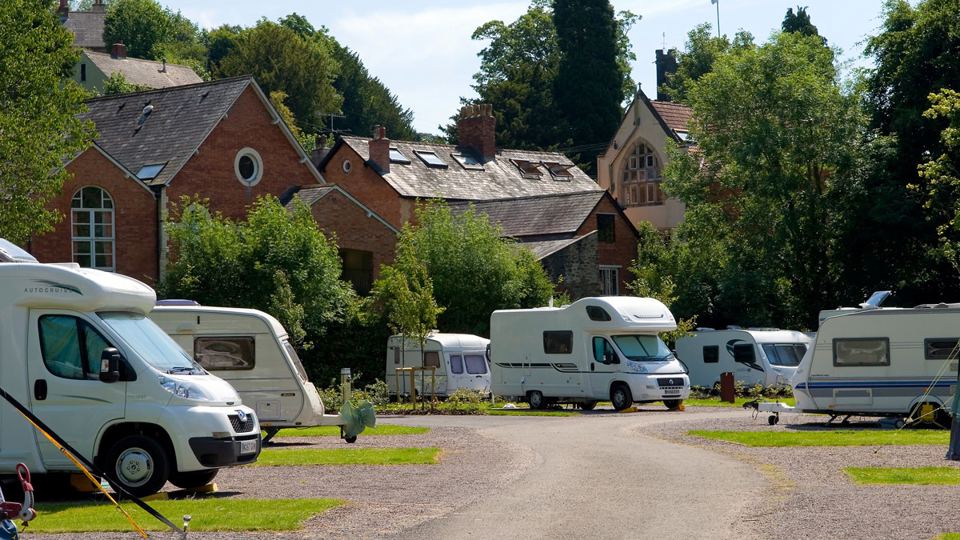 Motorhomes beside old buildings