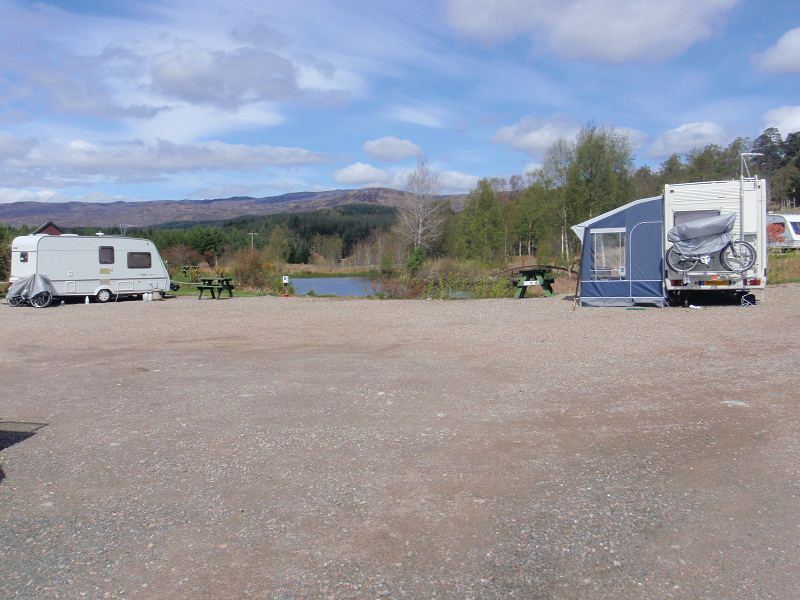 Caravans on gravel beside the loch