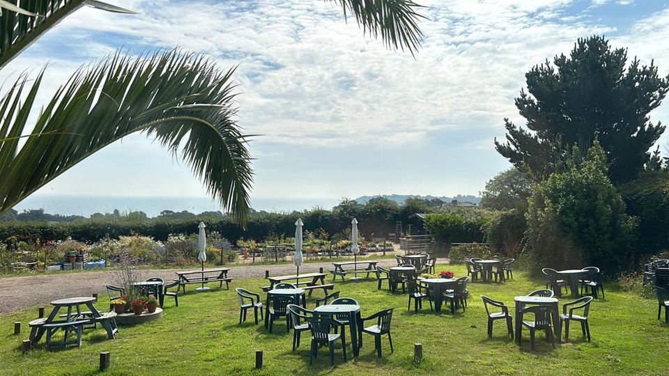 Café garden with tables and sea