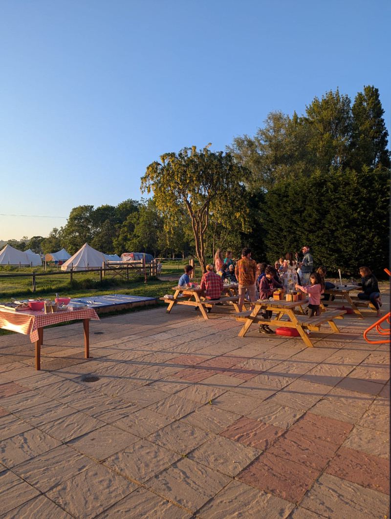 Terrace with bell tents beyond