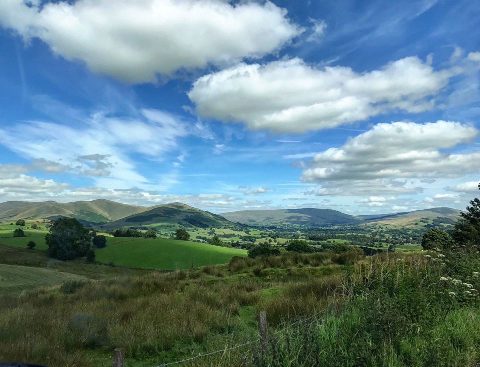 Hills and fields under blue sky