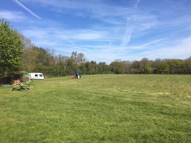 Open grass field with a caravan