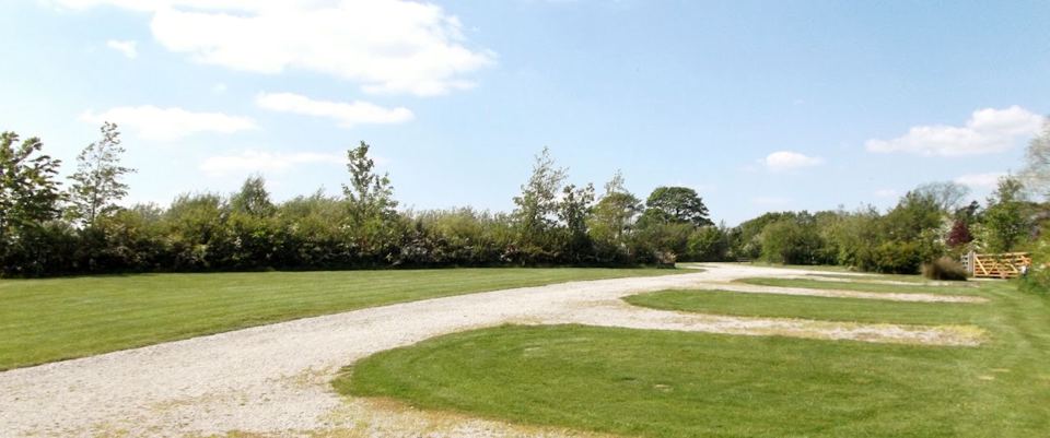 Gravel track beside grass pitches