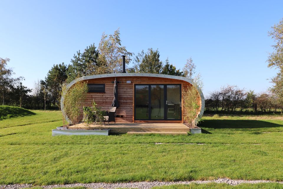 Escape pod with wood burner flue