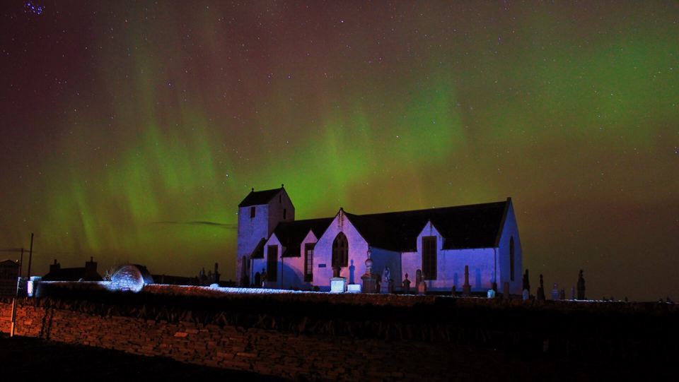 Northern lights over a church