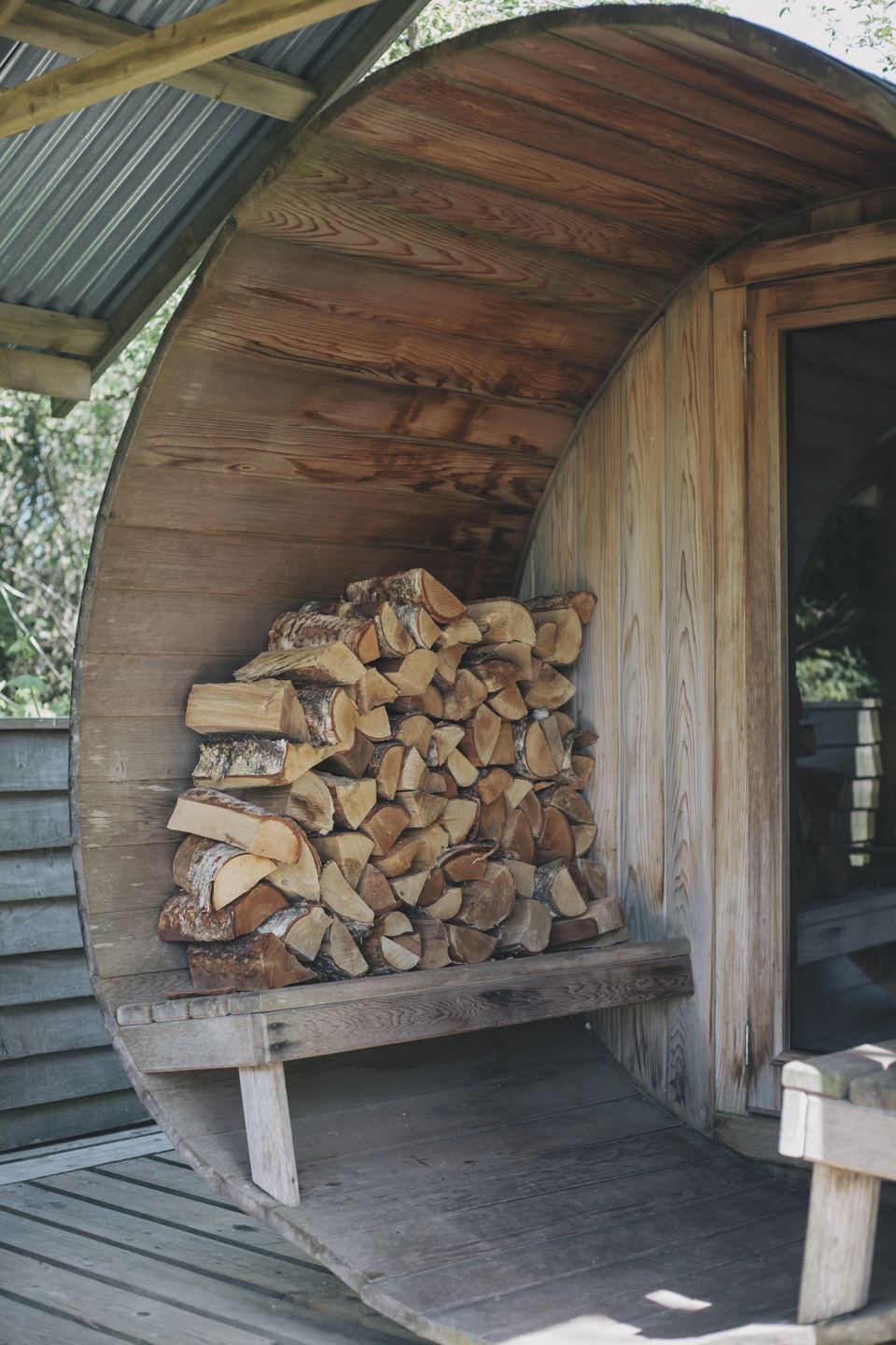 Cedar barrel sauna and log store