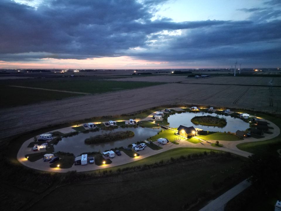 Lakeside pitches from above at dusk