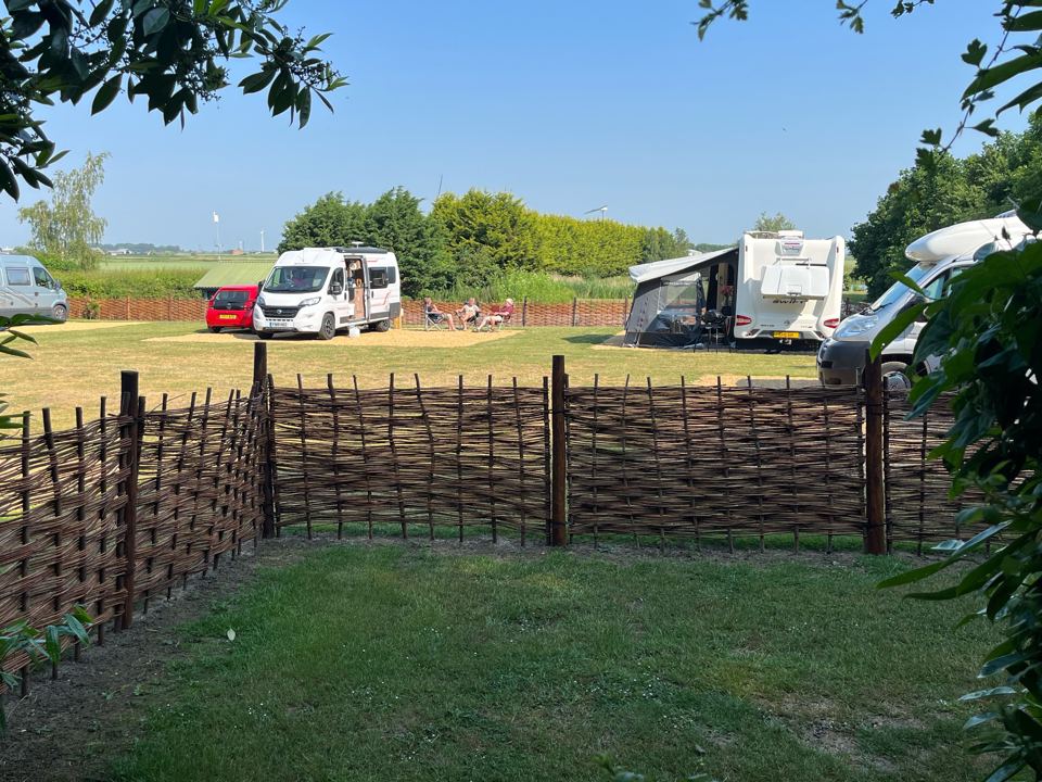 Pitches behind a woven fence