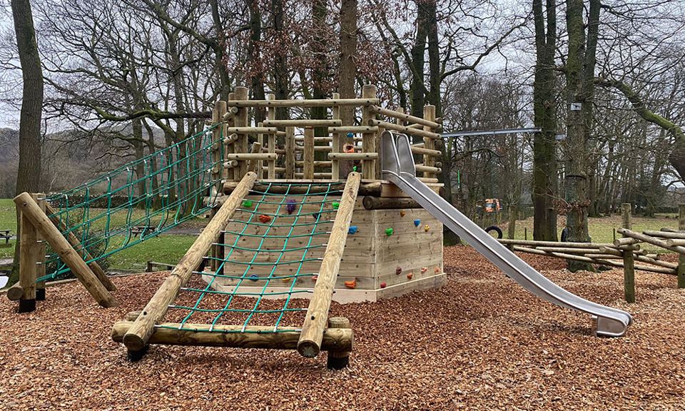 Climbing net and slide in the woods