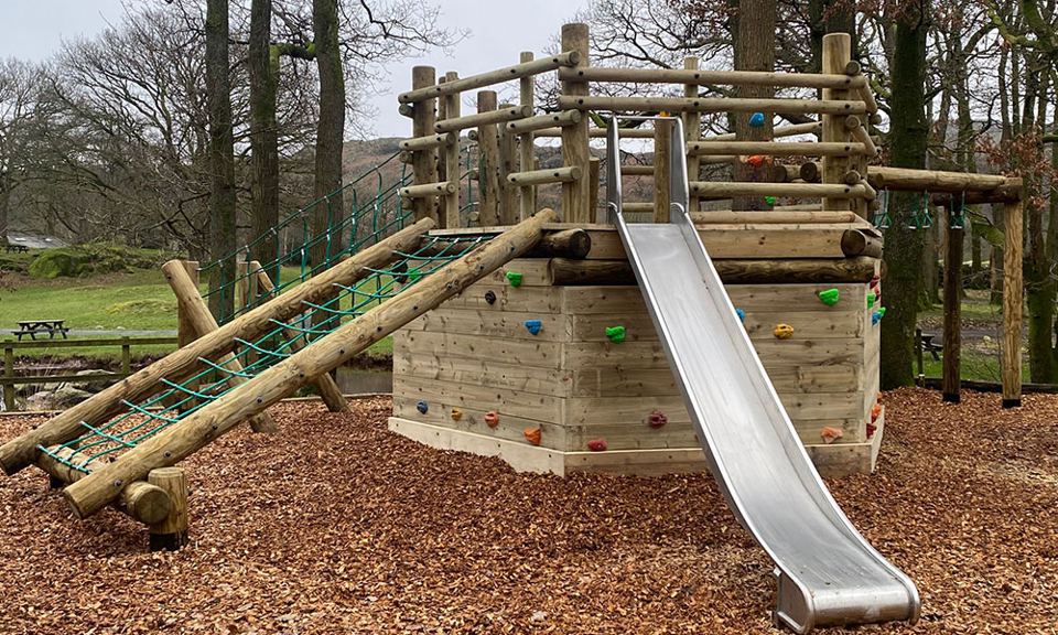 Wooden play structure with slide