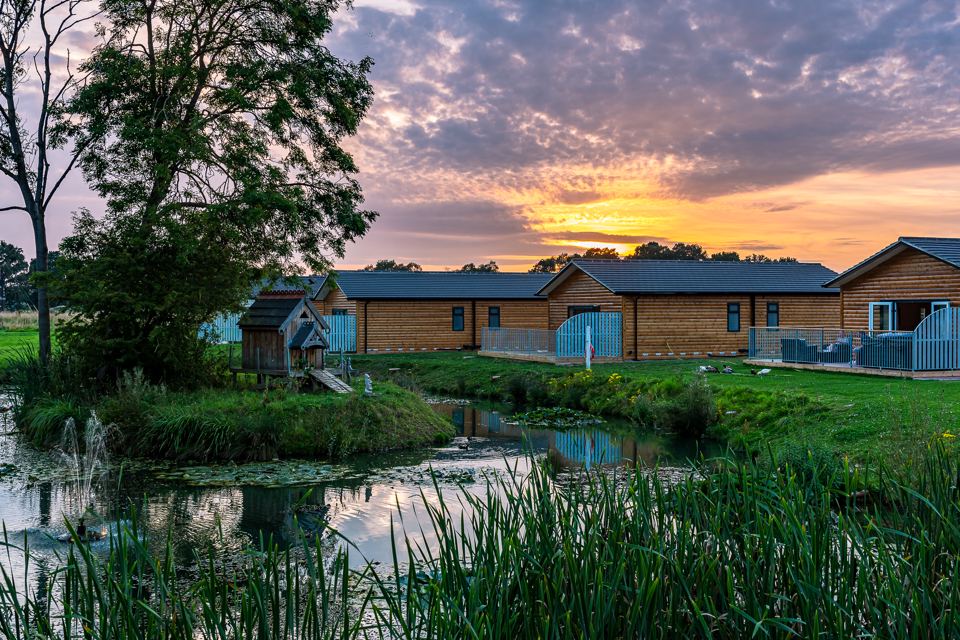 Cabins and pond at dusk