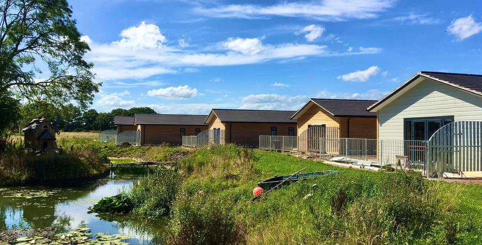 Log cabins beside the pond