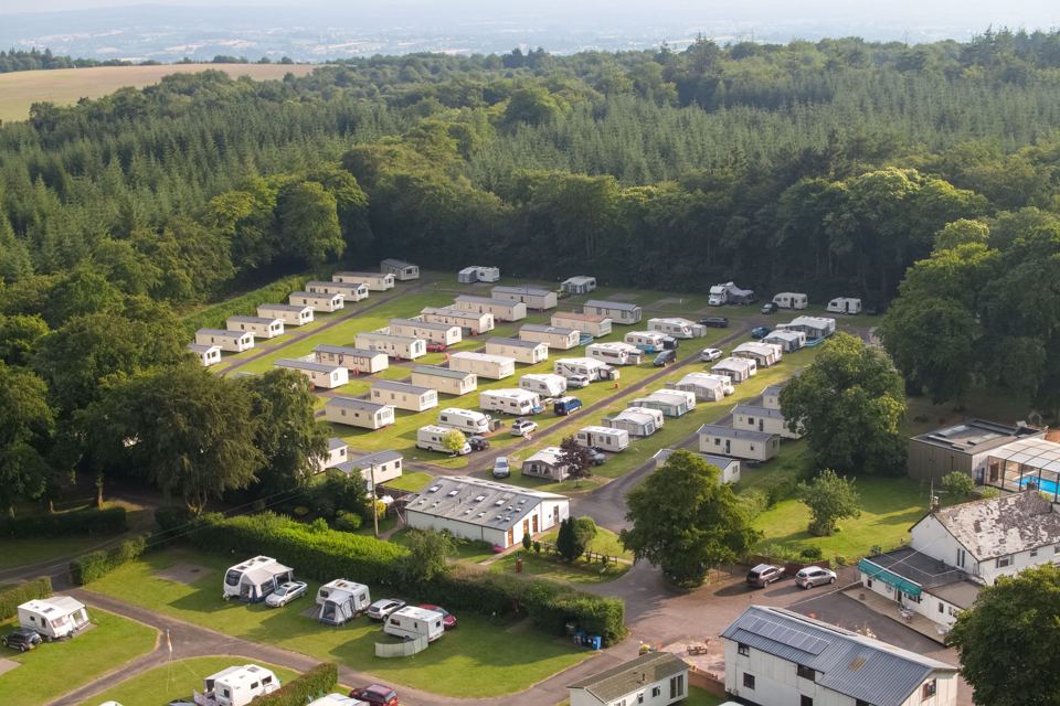 Aerial view of caravans among trees