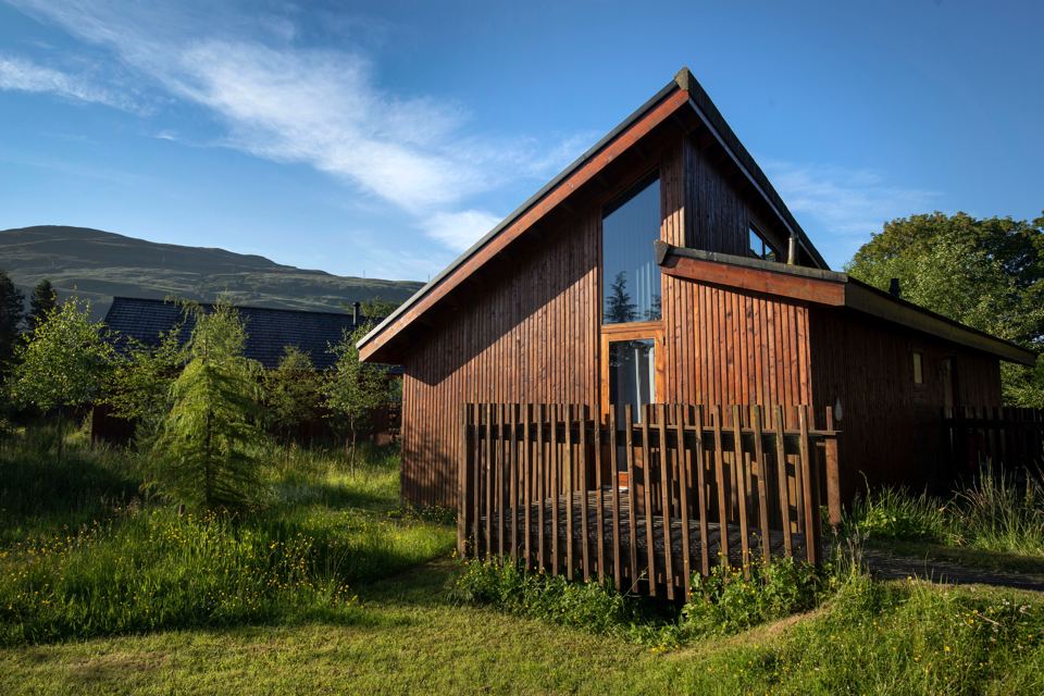 Timber cabin in the grass
