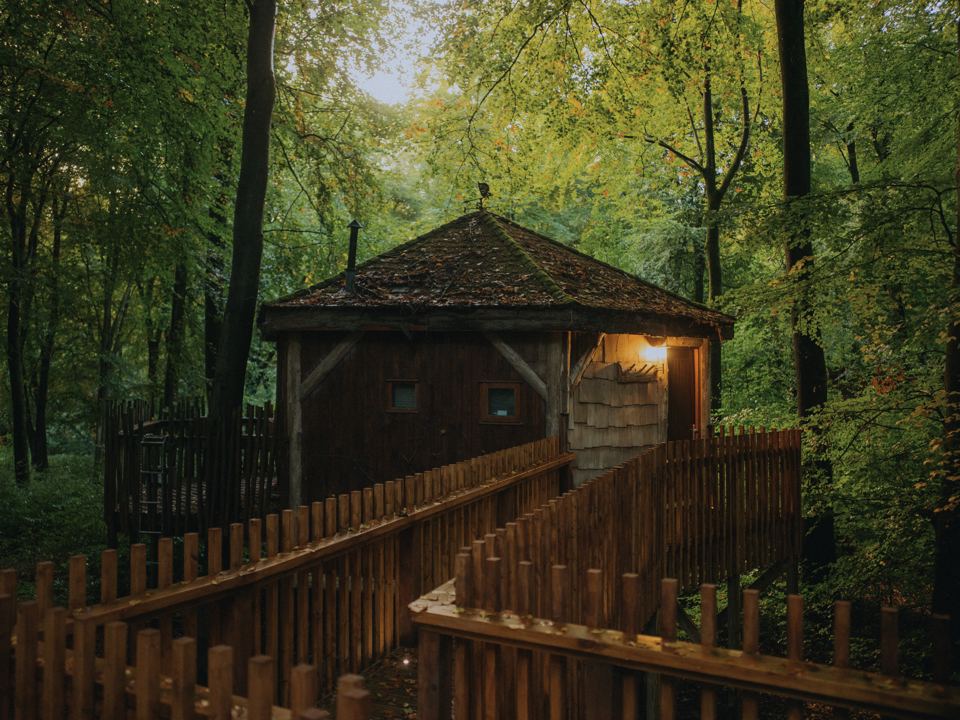 Round treehouse cabin on a walkway