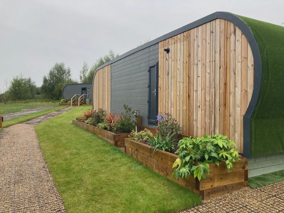 Timber lodge with raised flower beds