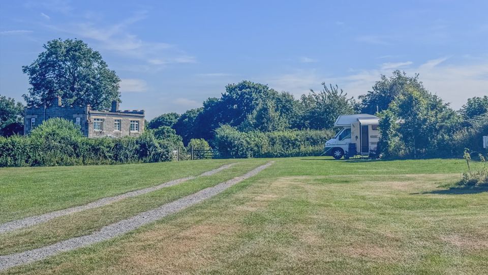 Grass field with motorhome