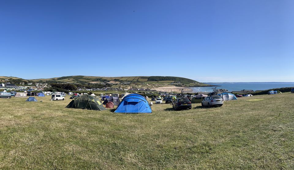 Tents across the field to the sea
