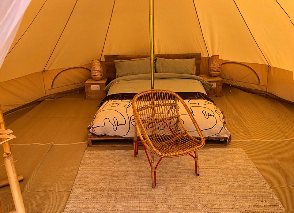 Bed inside a bell tent